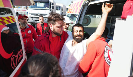 Syrian Red Crescent members transport injured civilians from the Kmeimim base, Latakia, Syria