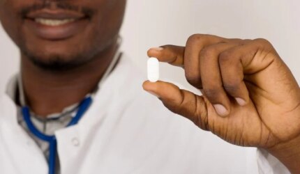 Dokter Dengan Stetoskop Memegang Obat Pil Putih