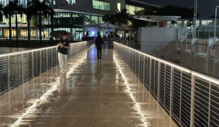 File photo: University of Miami students break out the umbrellas on the Lake Osceola bridge Thursday night, Sept. 18, 2025.